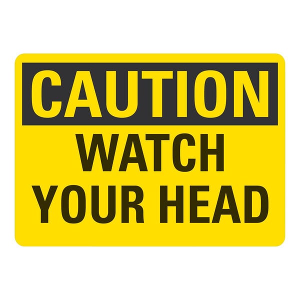 A yellow and black Lavex adhesive vinyl safety label with black text that says "Caution / Watch Your Head"