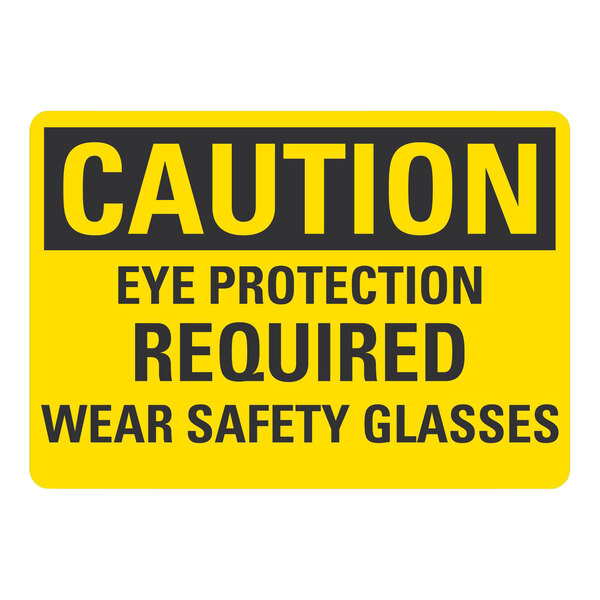 A yellow and black Lavex plastic safety sign that says "Caution Eye Protection Required Wear Safety Glasses"