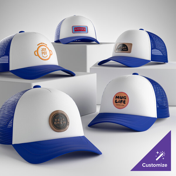 A group of customizable ivory and royal blue 5-panel foam trucker caps with mesh backs and various logo designs displayed on the front.