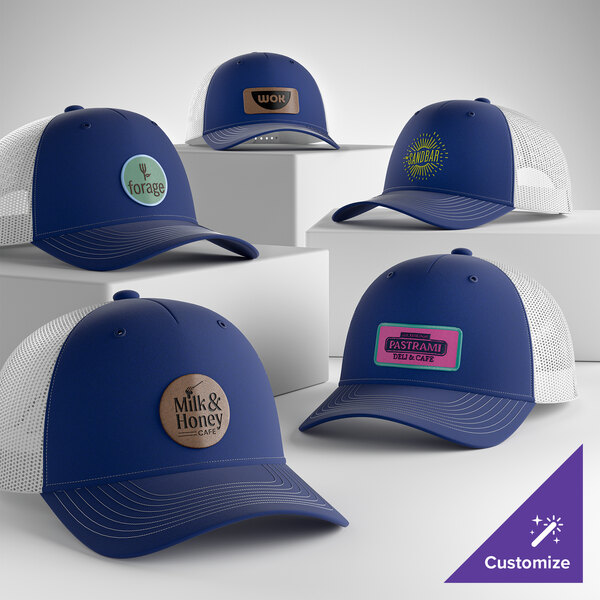 A collection of customizable blue and white mesh back trucker caps with various logo patches on the front.