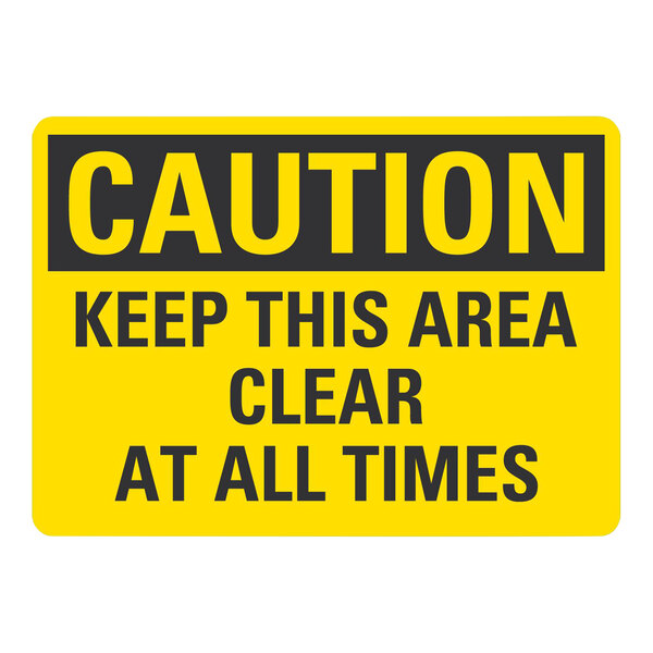 A yellow and black Lavex plastic safety sign that says "Caution / Keep This Area Clear At All Times"