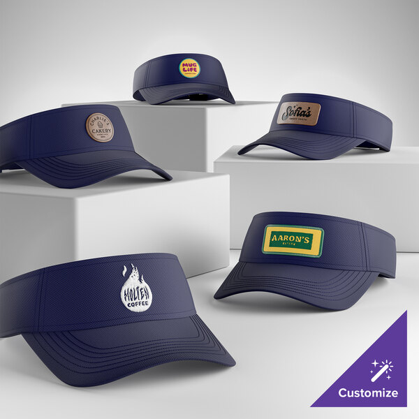 A collection of customizable navy blue moisture-wicking visors displayed on white blocks.