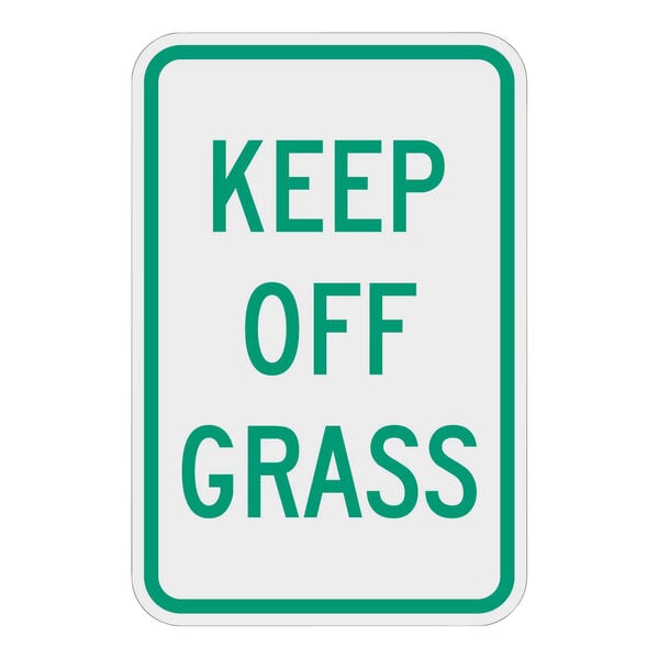 A white and green sign that says "Keep Off Grass" in green letters.