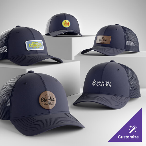 A collection of customizable true navy 6-panel trucker caps with mesh backs, featuring various logo designs on the front.