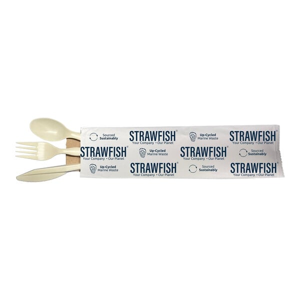 A white package of StrawFish natural cutlery with a straw and napkin inside.