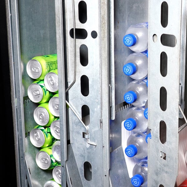 A vending machine interior stocked with cans and bottles of beverages.