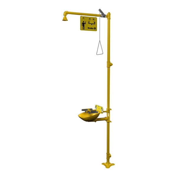 A yellow Bradley drench shower with a yellow sign above it.