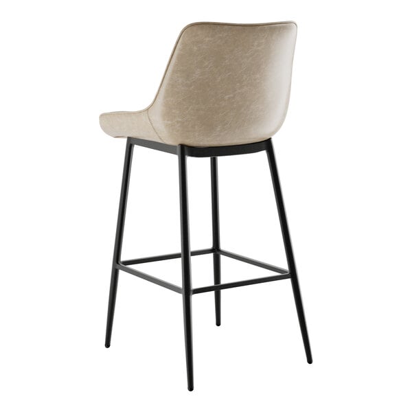 A Lancaster Table & Seating black barstool with a smokey beige tufted seat.