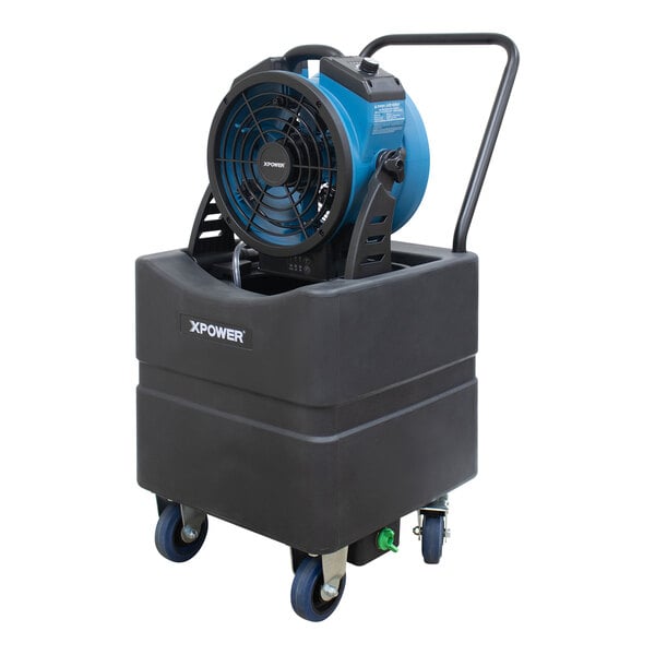 An XPOWER blue and black portable air circulator fan on a black container.