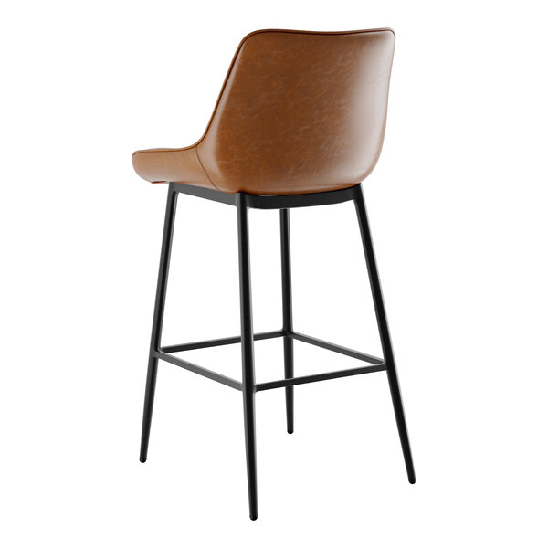 A brown leather Lancaster Table & Seating Mid-Century bar stool.