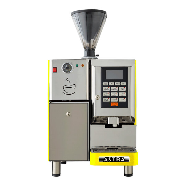 A yellow and black Astra Super Mega automatic coffee machine with a cup on it.