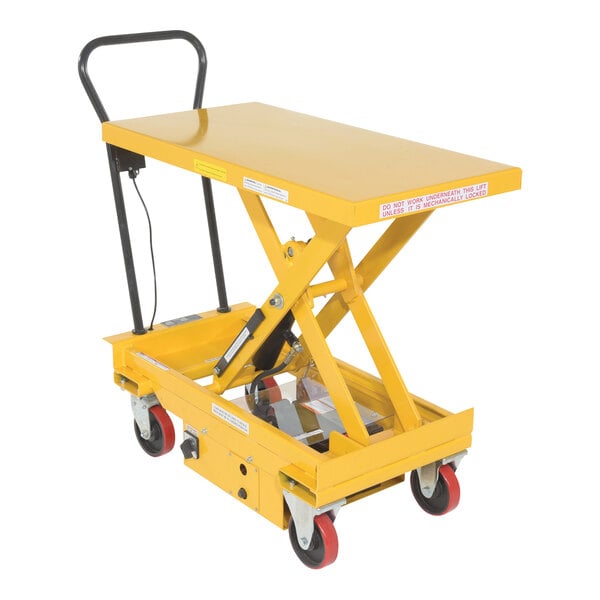 A yellow metal cart with black wheels.