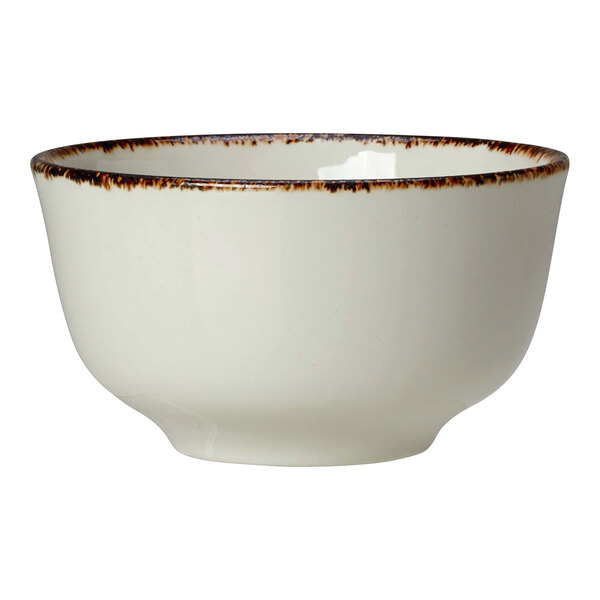 A white porcelain cup with brown specks.