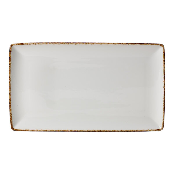 A white rectangular plate with brown speckled edges.