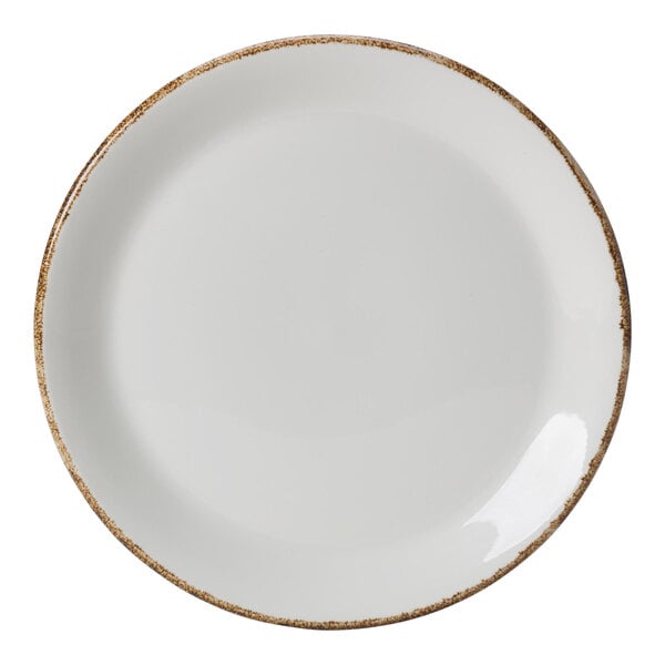 A white porcelain coupe plate with a brown speckled rim.