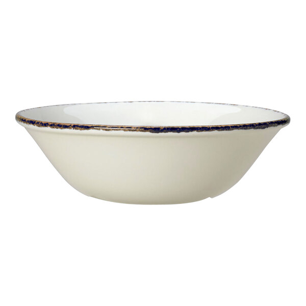 A white porcelain bowl with a blue dapple rim.