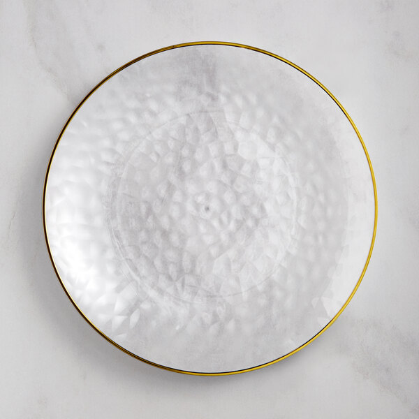 A Visions clear plastic coupe plate with a gold rim.