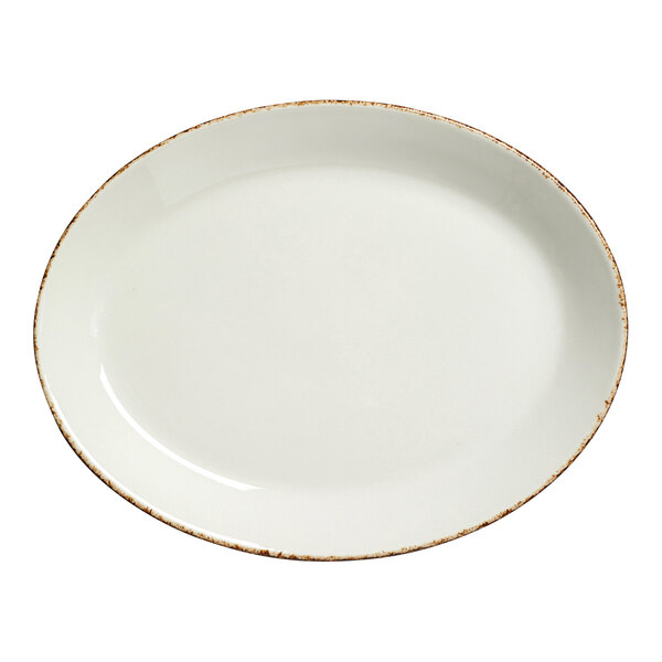 A white porcelain oval platter with brown speckled edges.