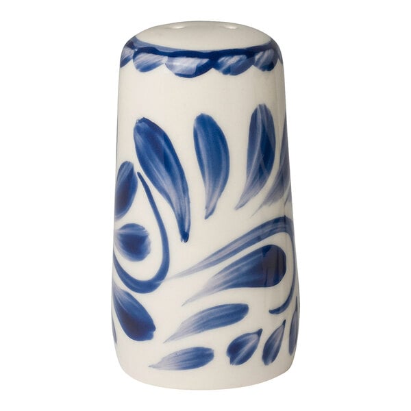 A white salt shaker with a blue swirl design.