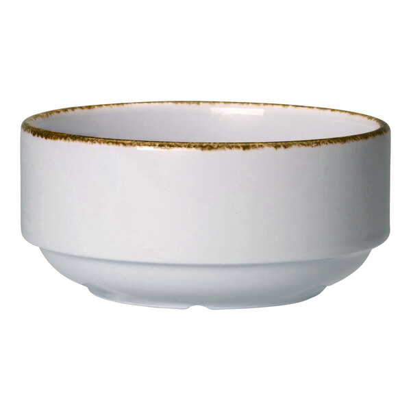 A white porcelain soup cup with brown specks.