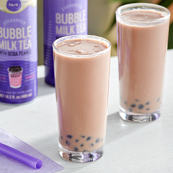 Two glasses of Evergreen taro bubble tea with purple straws.