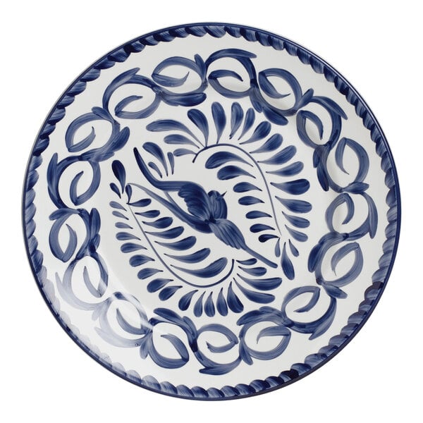 A white porcelain plate with a blue design of a bird on it.