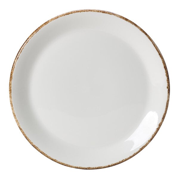 A close up of a white Brown Dapple porcelain coupe plate with brown speckled rim.