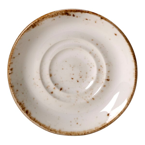 A close up of a Steelite Performance Craft white saucer with brown speckles.