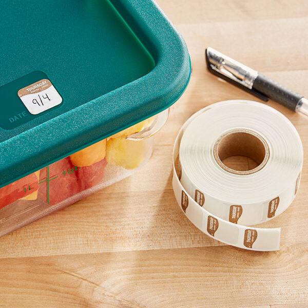 A plastic container of fruit with a DayMark Dissolvable Thursday label on it.