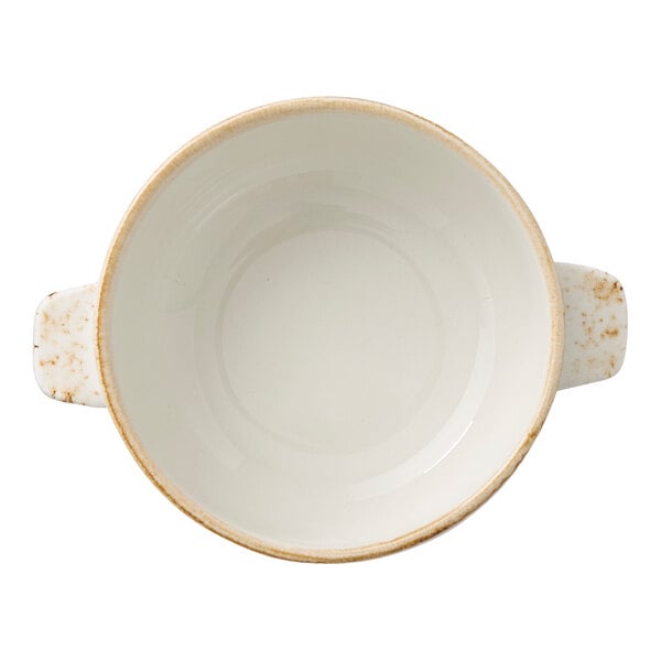 A white ceramic soup bowl with two small handles and a slightly speckled rim.