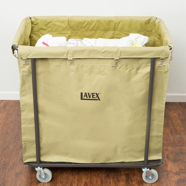 A Lavex large white canvas liner inside a metal frame laundry cart.