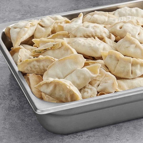 A metal tray filled with Chef One vegetable dumplings.