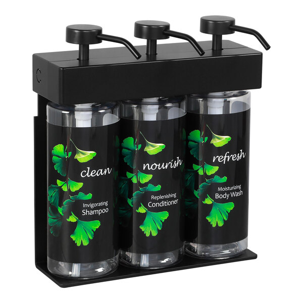 A black wall mounted dispenser with three oval bottles with Ginkgo labels.