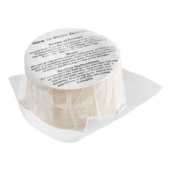 A stack of white Twin Marquis Shanghai-Style Dumpling Wrappers packages.