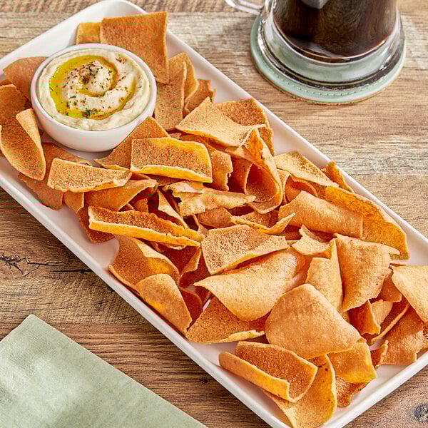 A plate of Issa's Restaurant Style Pita Chips with dip.