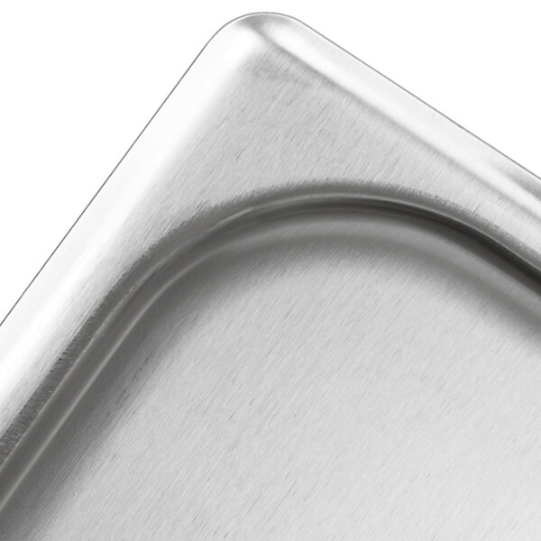 A Vollrath stainless steel deli pan with a lid.