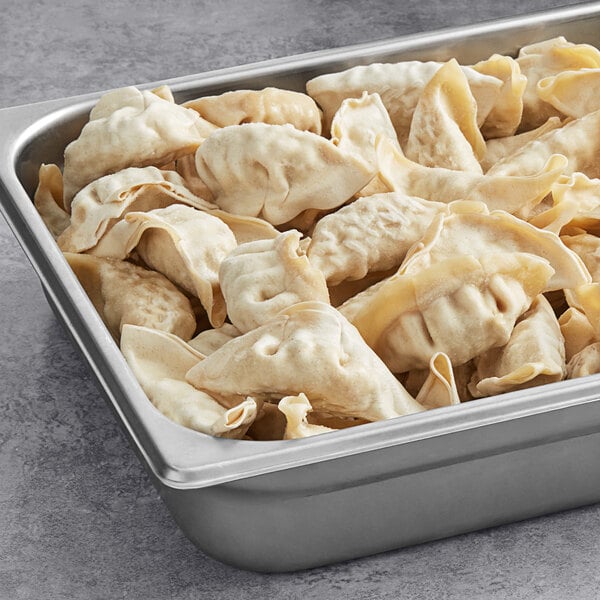 A metal pan filled with Chef One pork and vegetable dumplings.