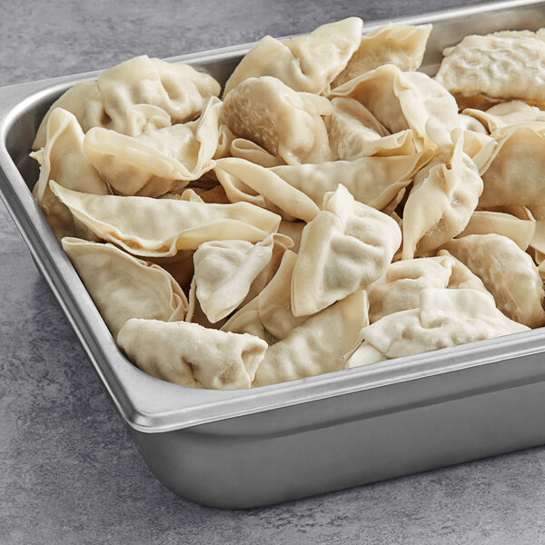 A silver pan filled with Chef One Chicken Lemongrass Potstickers.