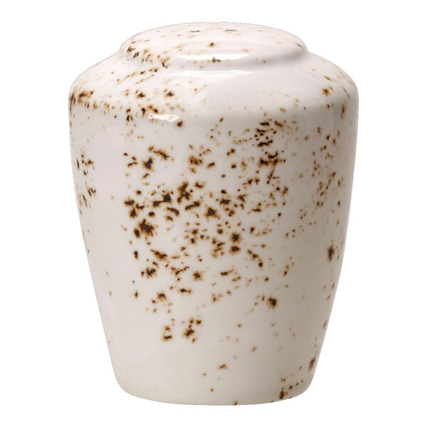 A white ceramic pepper shaker with brown speckles.