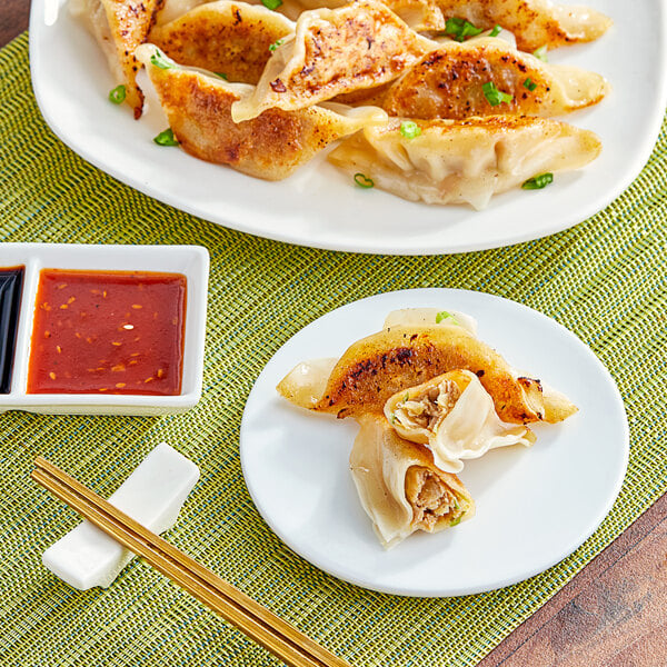 A plate of Chef One Chicken Teriyaki Potstickers with dipping sauce.