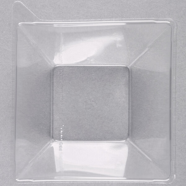 A clear plastic Fineline dome lid on a square container.