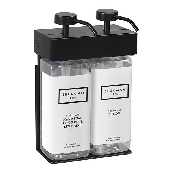 A black wall-mounted dispenser with two rectangular bottles.