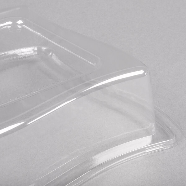A clear plastic container with a clear dome lid on top.