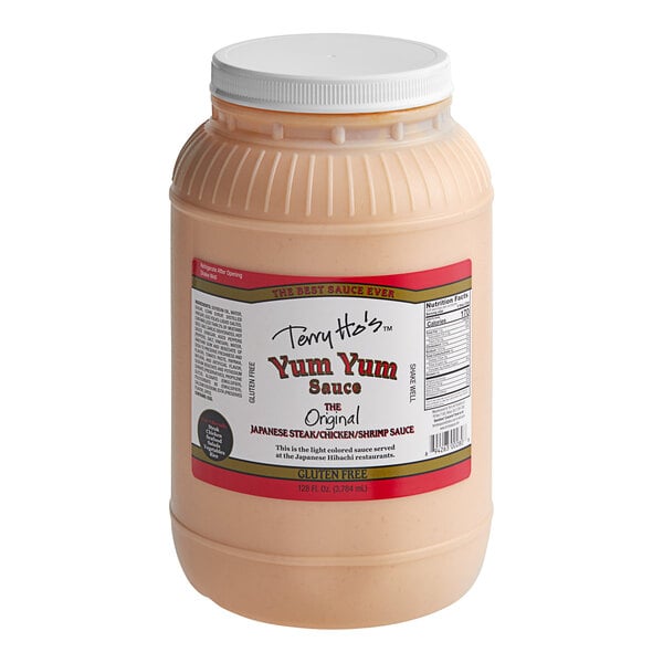 A plastic container of Terry Ho's Original Yum Yum Sauce with a white cap.