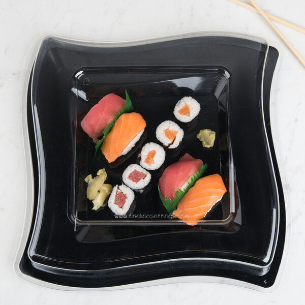 A clear dome lid on a black plate with sushi.
