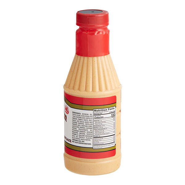 A close-up of a bottle of Terry Ho's Spicy Yum Yum sauce with a red lid.