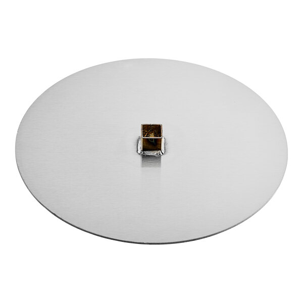 A silver circle with a square object in the middle.