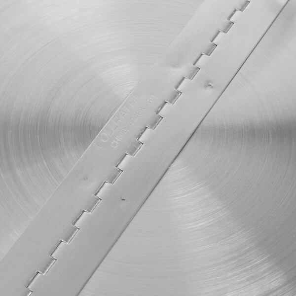 A Vollrath Kool Touch stainless steel hinged cover with a metal strip with holes on it.