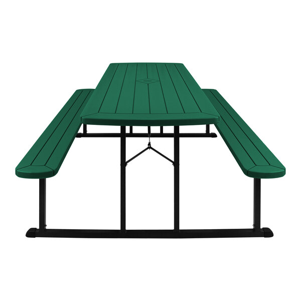 A green picnic table with black legs and benches.