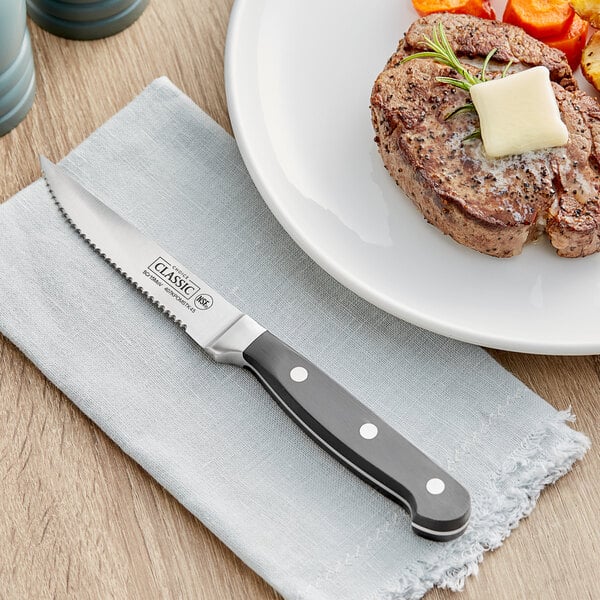 A steak on a plate with a Choice Classic steak knife.